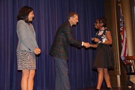 Senior Jamila Blair shakes hands with Head of School Audrius Barzdukas. 