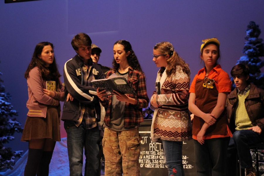 Freshman Sophia Falbo reads from a notebook during Snow Angel.