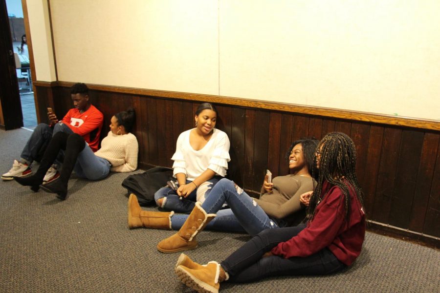 Sophomores Jendayi Leben-Martin, Kayla White and junior Kaelah Pyronneau in the library hallway.