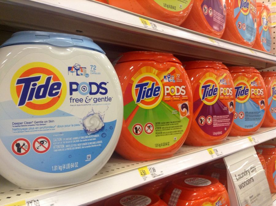 Tide Pod boxes line the walls of a supermarket.