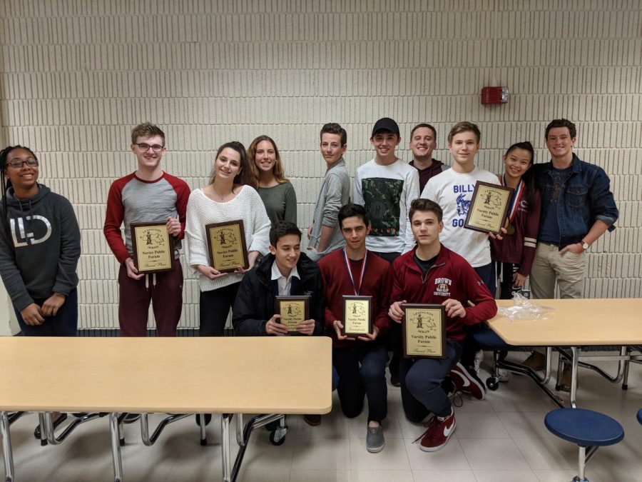 The debate team holds up its trophies after a competition in Lexington, Mass. 