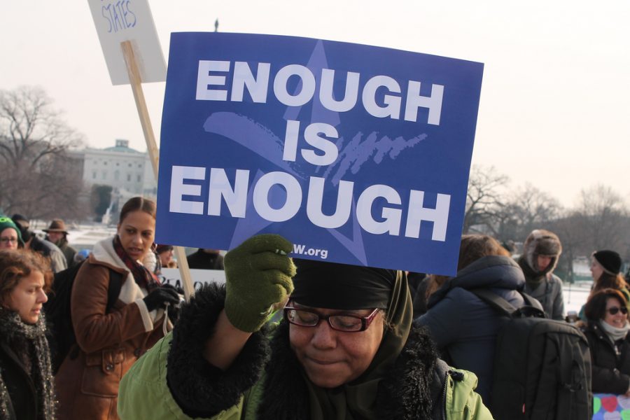 A woman holds up a sign during a Washington, D.C., march in January 2013. Protests to reform gun laws have been ongoing for years. 